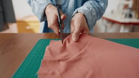 Closeup view of cutting fabric in atelier, woman hands with scissors and tissue. Professional seamstress or student of sewing classes preparing details for new dress, female tailor or fashion designer - Powered by Shutterstock - Get 15% off with code: PIKWIZARD15