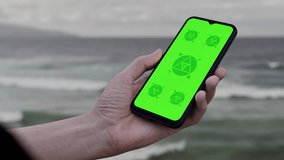 Caucasian White middle aged male using smartphone with a blank green screen. Mobile app video mockup. Vertical phone orientation - Powered by Shutterstock - Get 15% off with code: PIKWIZARD15