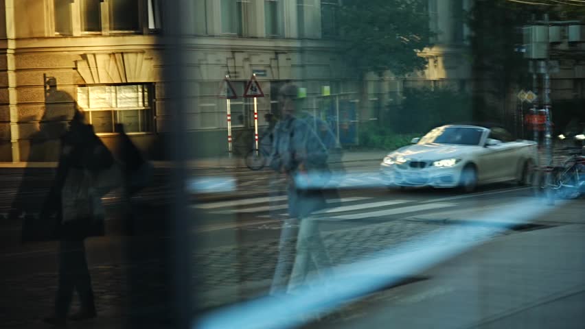 City bustle  - walking people, trams, cars, buses, intersections, etc. in slow motion.