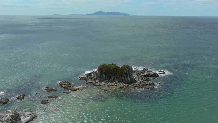Rocky island off the coastline of Mangawhai heads, Northland, New Zealand.