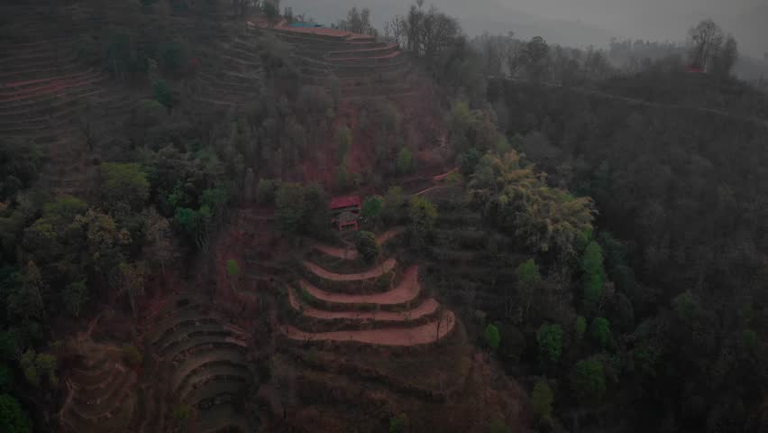Aerial View of Traditional house in the Rural Village of Kaski near Pokhara Nepal with beautiful hills and Himalayas in the background, Beautiful Landscape, evening shot