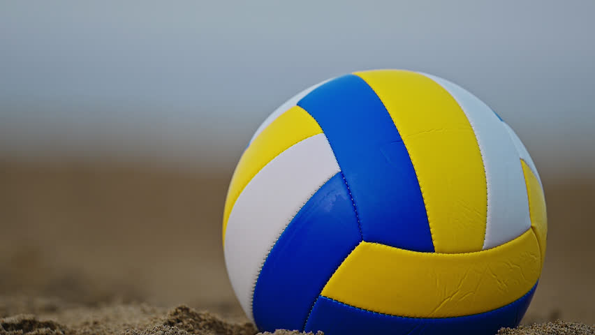 Beach Volleyball. Game ball under sunlight and blue sky. 4k Footage