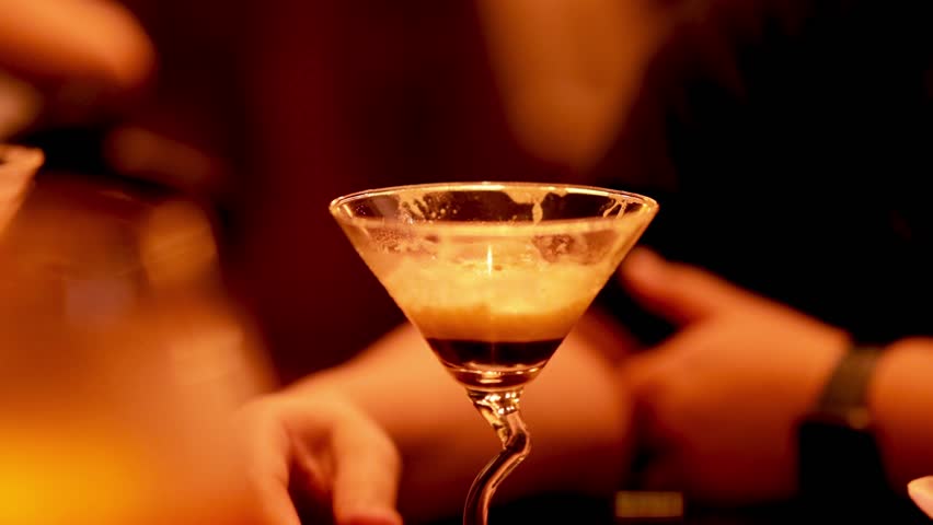 Person savoring a cocktail in a bar