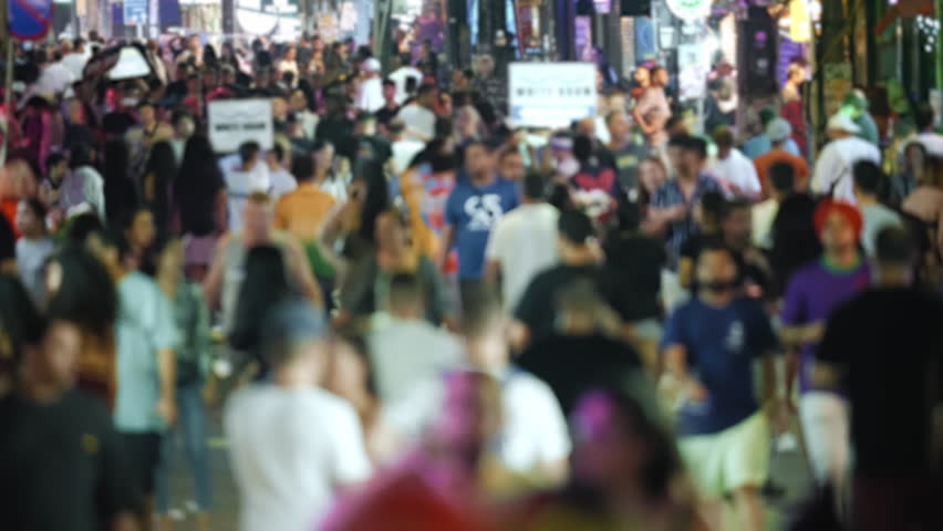 Many people walk Thai city street. Fun Thailand night life. Rush hour crowd. Lots of drunk tourist hang out nightclub. Busy pedestrian pass by nightlife bar. Urban neon light sign. Public club hopping