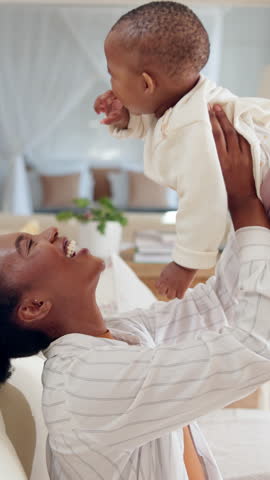 Happy, playing and mom on sofa with baby, laughing and fun bonding together in living room. Smile, black woman and kid on couch with love, playful games and support in child development care in home