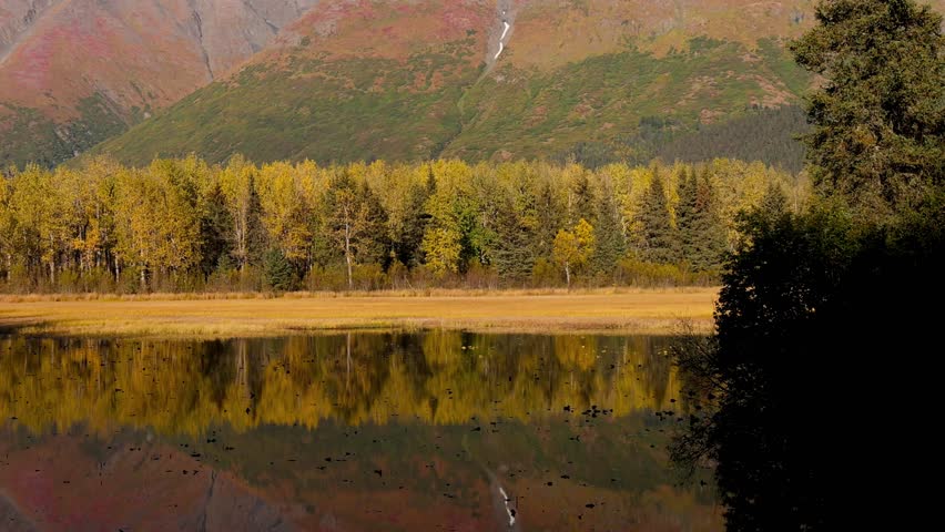 Scenic landscape perfect reflections along Seward highway in Alaska during autumn time.