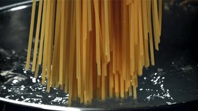 Spaghetti falling into boiling water. Filmed on a high-speed camera at 1000 fps. High quality FullHD footage - Powered by Shutterstock - Get 15% off with code: PIKWIZARD15
