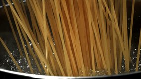 Spaghetti falling into boiling water. Filmed on a high-speed camera at 1000 fps. High quality FullHD footage - Powered by Shutterstock - Get 15% off with code: PIKWIZARD15