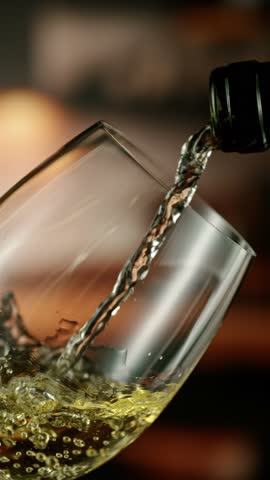Close-up of white wine pouring into glass , slow motion, filmed on high speed cinematic camera at 1000 fps