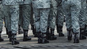 group of soldiers performing mark time drill at a military parade. Black military boots. Military drill command MARK TIME. Military gray camouflage suit - Powered by Shutterstock - Get 15% off with code: PIKWIZARD15