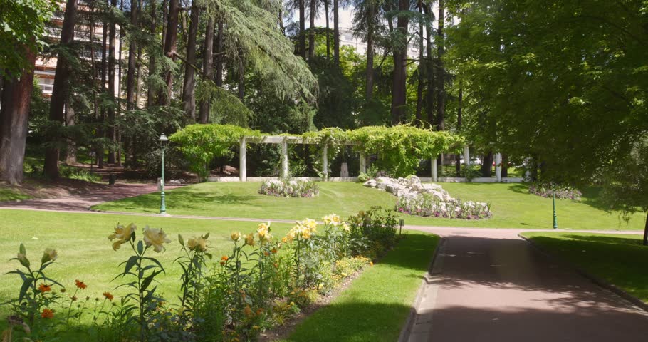 Profile view of Parc floral des thermes (thermal floral park) in Aix-les-Bains, France during daytime. 4k.