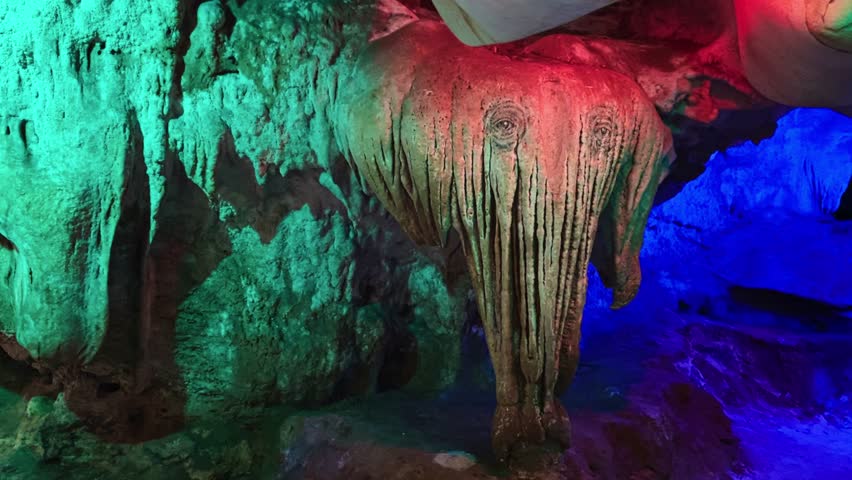 A Beam of Vibrant Light Casting Hues Over a Limestone Formation Resembling an Elephant at Kek Look Tong Cave in Ipoh, Malaysia - Close Up