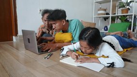 Asian Family Activity. Father Helping Son Doing Homework Using Laptop And Daughter Writing On Book - Powered by Shutterstock - Get 15% off with code: PIKWIZARD15
