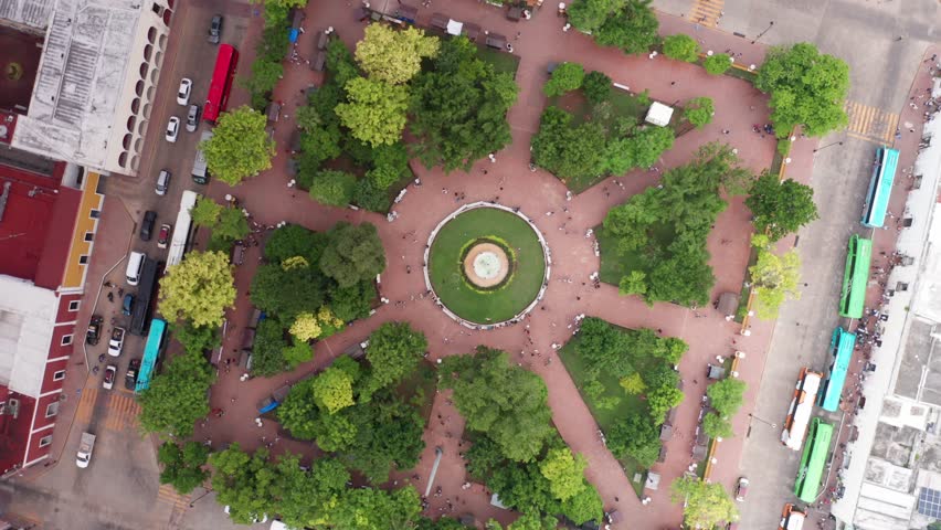 Bird's eye aerial spiral shot of Parque Principal Francisco Cantón Rosado in Valladolid, Mexico. 4K
