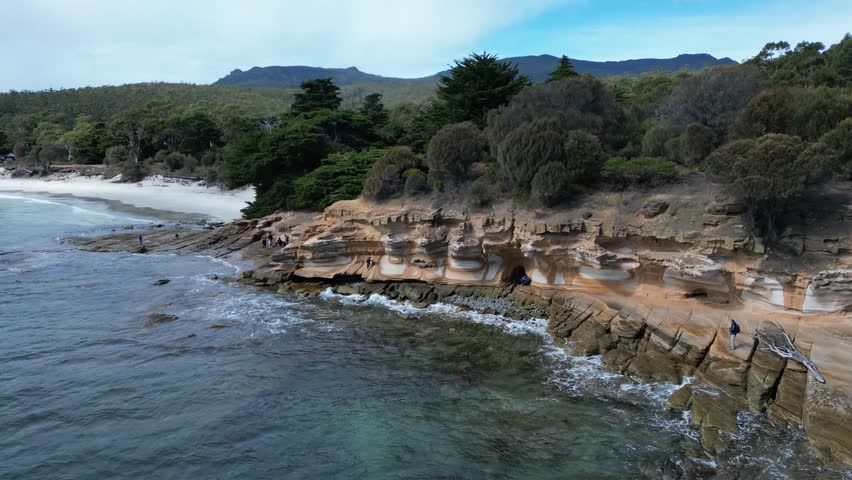An aerial footage of the scenic Painted Cliffs on Maria Island, on a sunny day in Tasmania, Australia