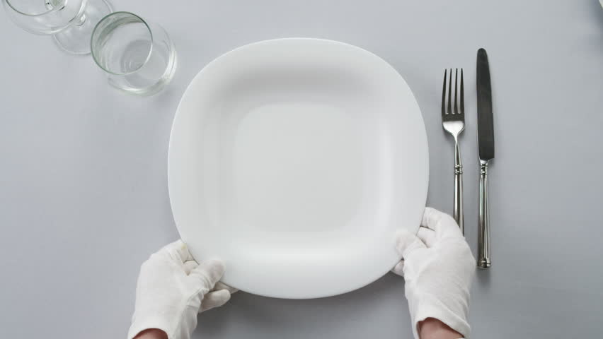 Elegant table setting with white tableware plates, cutlery, and glassware for a classy dining, fancy expensive restaurant dinner - Powered by Shutterstock - Get 15% off with code: PIKWIZARD15