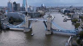 Aerial view of the open lifted Tower Bridge of London, England, during a cloudy autumn day - Powered by Shutterstock - Get 15% off with code: PIKWIZARD15