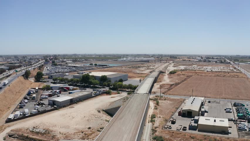 Rising and panning aerial shot of the termination point of the California High-Speed Rail in Fresno, California. 4K