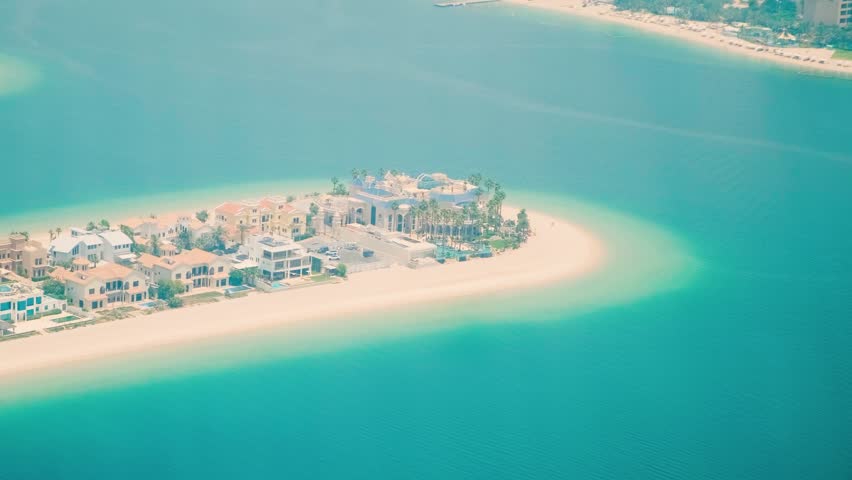 Aerial view of luxury villas on The Palm Jumeirah artificial island with sandy beach and turquoise waters of Arabiani Gulf n Dubai city, United Arab Emirates