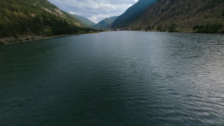 FPV drone flies fast over a lake, revealing the town of Georgetown, Colorado.