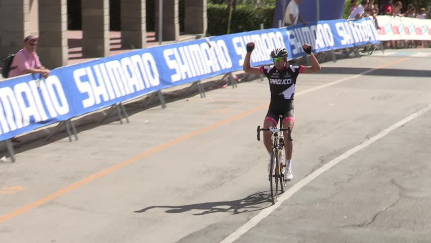 MONEGLIA, ITALY – SEPTEMBER 11: Single cyclist being applauded as he reaches the finish line on September 11 2011 in Moneglia

