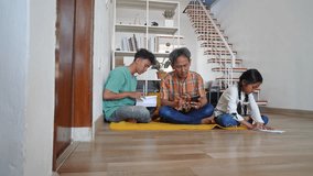 Asian Family Daily Activity, Father Using Smartphone While Son And Daughter Reading A Book - Powered by Shutterstock - Get 15% off with code: PIKWIZARD15