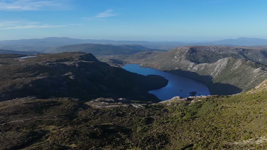 Dove Lake between mountains, Cradle Mountain Area in Tasmania, Australia. Aerial drone panoramic view