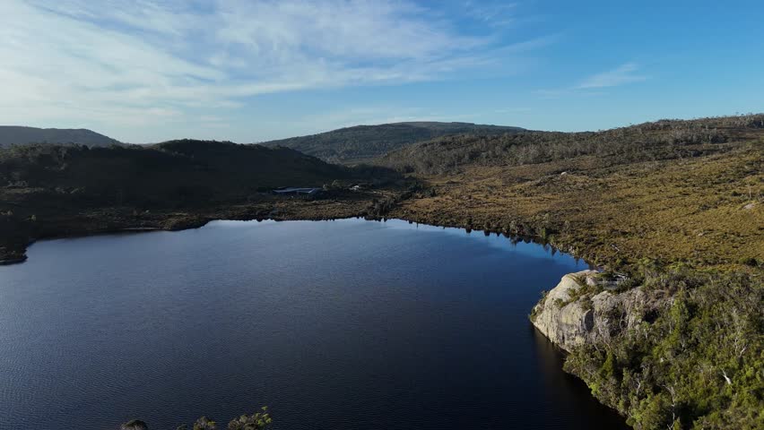 Dove glacier lake and visitor center in national park of Tasmania. St Clair park with cradle mountain. Aerial wide shot during sunny day.