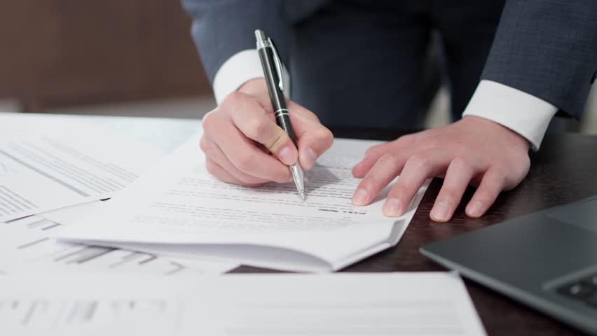 The hands of a businessman checking documents in a hurry