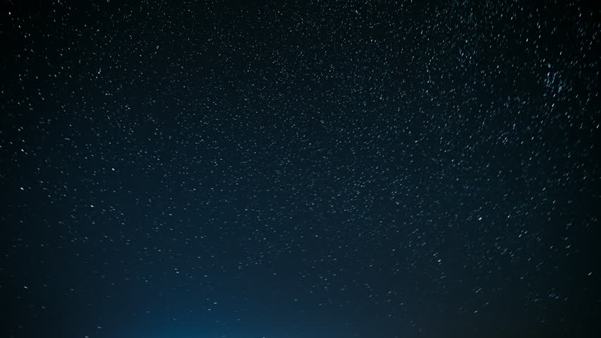 Meteors Fly Across Sky. 4k Time Lapse Night Starry Sky Stars And Meteoric Track Trails. Spin Trails Of Stars. Star Trails On Night Sky Background. Meteors Cross Dark Blue Sky. Amazing Stars Effects In