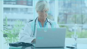 Animation of data processing over senior caucasian doctor using laptop. Global medicine, computing and digital interface concept digitally generated video. - Powered by Shutterstock - Get 15% off with code: PIKWIZARD15