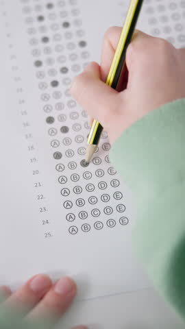 Hands, writing and student with multiple choice test in classroom at school for scholarship admission. Education, learning and closeup of person study with practice exam, assessment or question paper