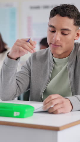 Student, anxiety and writing in exam with education, thinking and stress in classroom for scholarship. Male person, headache and high school in learning, development and academy for study or research