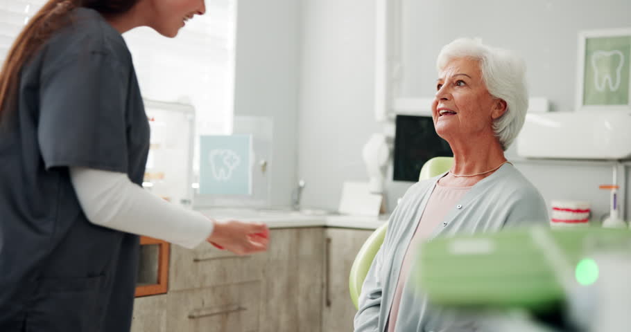 Help, holding hands and senior woman at dentist for cleaning, oral hygiene and medical checkup. Consulting, dental and healthcare advice with person at clinic for orthodontist, treatment and exam