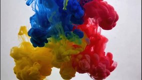 Vivid blue, red, and yellow ink clouds blend together in water, creating a dynamic and vibrant abstract art composition. - Powered by Shutterstock - Get 15% off with code: PIKWIZARD15