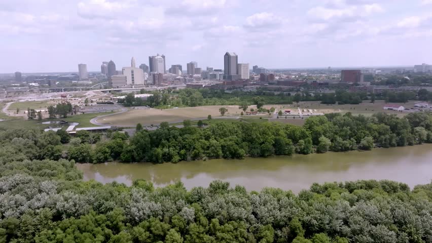 Wide view of Columbus, Ohio skyline with drone video moving in. circle to the right.