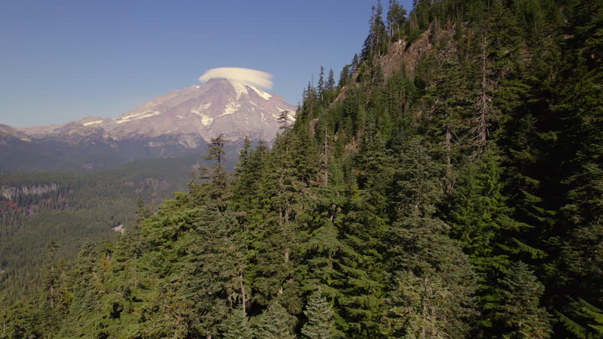 Lenticular Cloud Over Mount Rainier with Forested Mountain Slope in Foreground