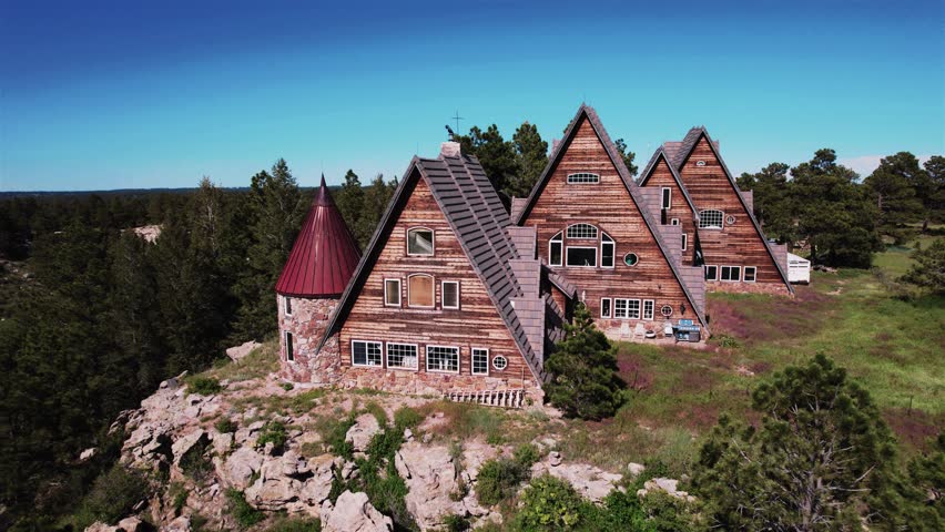 House on a Colorado Cliff Pull Back 4K features drone footage of an interesting set of A frame style buildings on the top of a cliff in Colorado with the camera action moving away from the building.