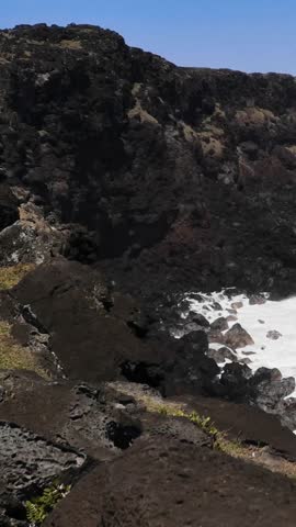 Rocky Coastline with Ocean Waves and Foam, Easter Island, Chile - Vertical 4K Video
