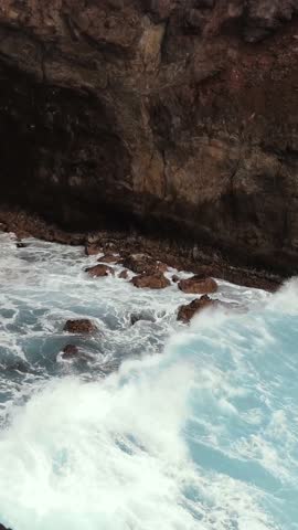 Dramatic Ocean Waves Crashing into a Cave, Easter Island, Chile - 4K Vertical