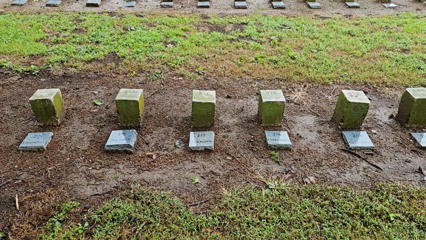 Rows of headstones of Confederate dead stand in rank and file in the McGavock Confederate Cemetery in Franklin, Tennessee on a somber rainy day-Tilt
