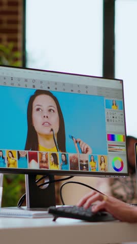 Vertical Video Freelance designer works on a photo editing project in a remote office, using advanced design software. Home workspace promotes creativity and innovation for online work. Camera B.