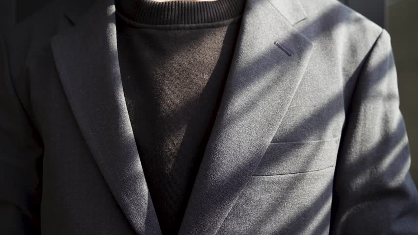 footage video of a person in a suit took out a red credit card from his suit pocket