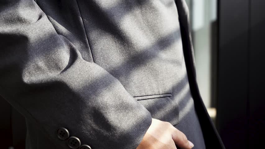 footage video of a person in a suit took out a red credit card from his suit pocket