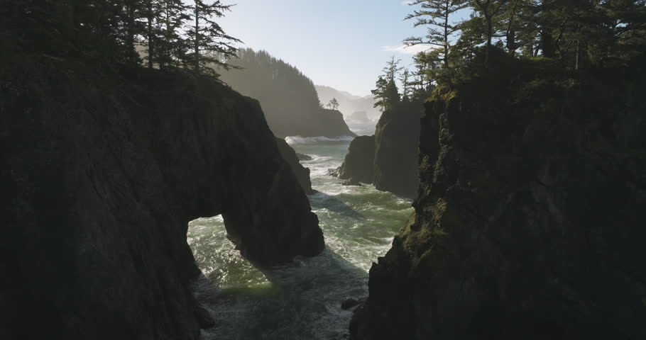 Aerial view of sea stacks, cliffs, and natural bridges at Samuel H Boardman, with ocean waves breaking through the rocky formations