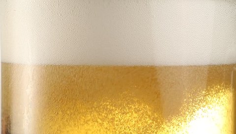 Pouring light beer into glass.