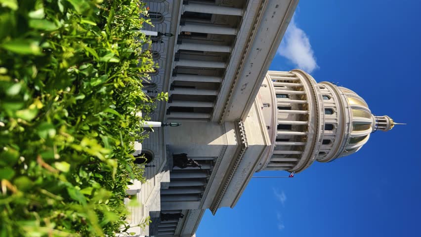 The famous building of the National Capitol in Cuba. HAVANA - DECEMBER 20, 2023: The entrance staircase and the dome of the Capitol in the center of Havana against the background of a blue sunny sky.