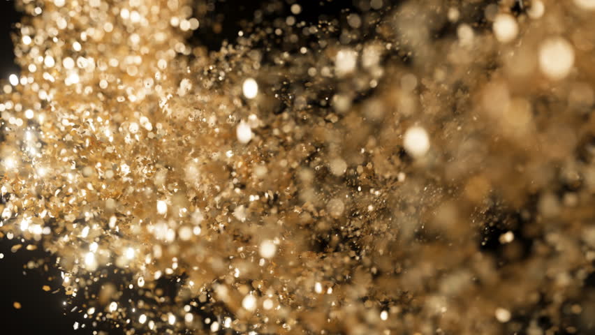 Slow-motion golden glitter backdrop with gold particles drifting gracefully against a dark background