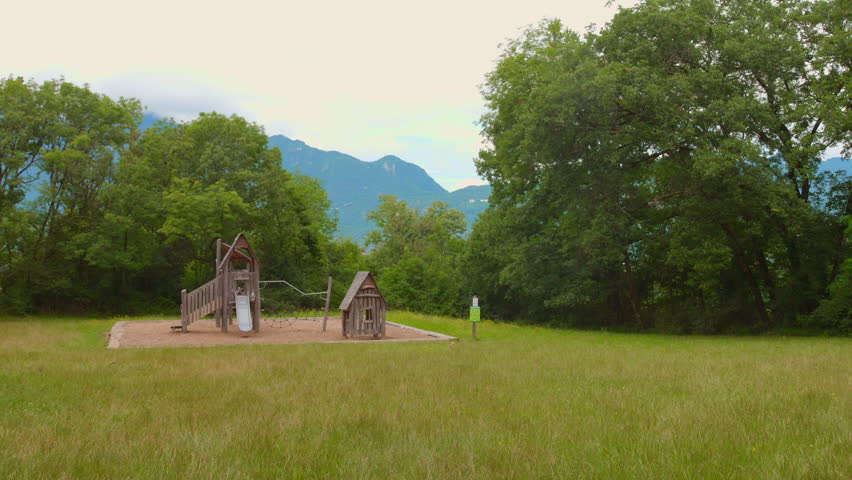Motion video of a random park with abandoned hut surrounded with greenery in France.