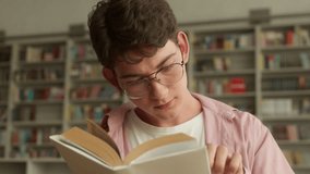 Caucasian teen boy schoolboy student concentrated guy clever male pupil son man teenager glasses reading book read literature studying learning in school university academy college library education - Powered by Shutterstock - Get 15% off with code: PIKWIZARD15